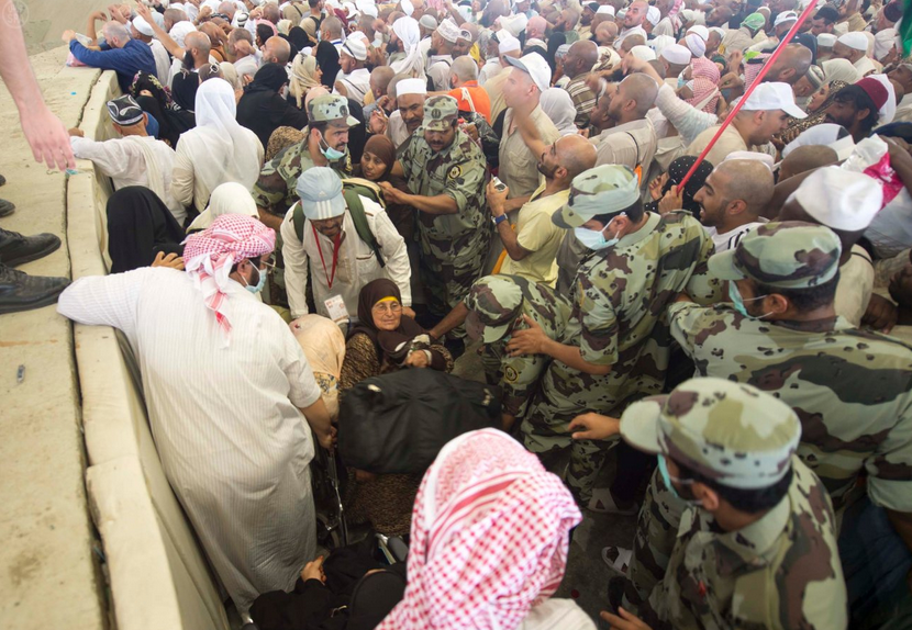 Security forces assist disabled Muslims performing the Hajj. Photo via SPA.