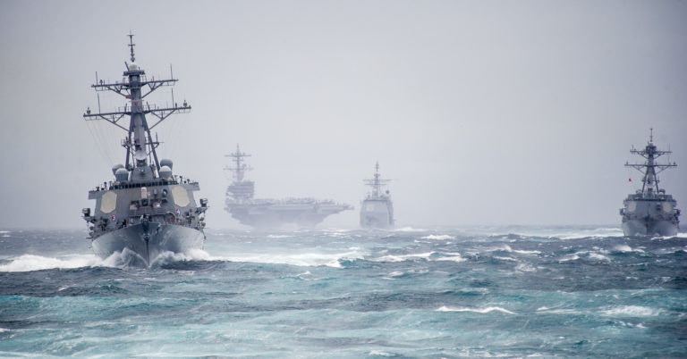 The guided missile destroyer USS Arleigh Burke (DDG 51), foreground left, leads the guided missile destroyer USS Truxtun (DDG 103), right, the guided missile cruiser USS Leyte Gulf (CG 55), center, and the aircraft carrier USS George H.W. Bush (CVN 77) during a strait transit exercise in the Atlantic Ocean Dec. 10, 2013. The ships were part of the George H.W. Bush Carrier Strike Group and were underway participating in a composite training unit exercise in preparation for a scheduled deployment. (DoD photo by Mass Communication Specialist 2nd Class Justin Wolpert, U.S. Navy/Released)